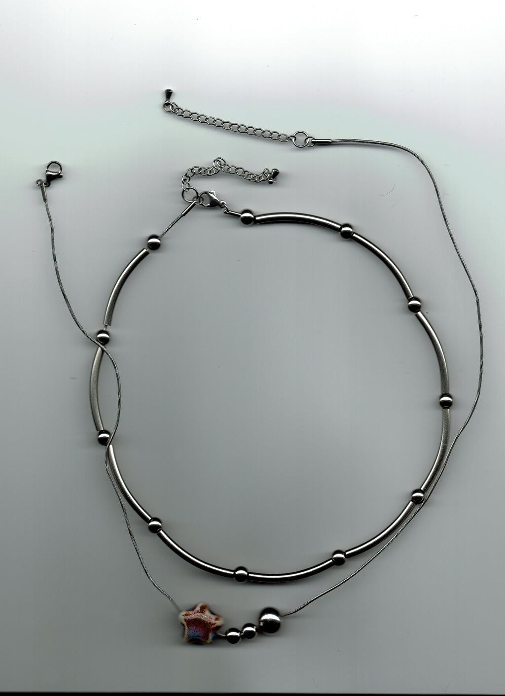 stainless steel necklaces on a white background